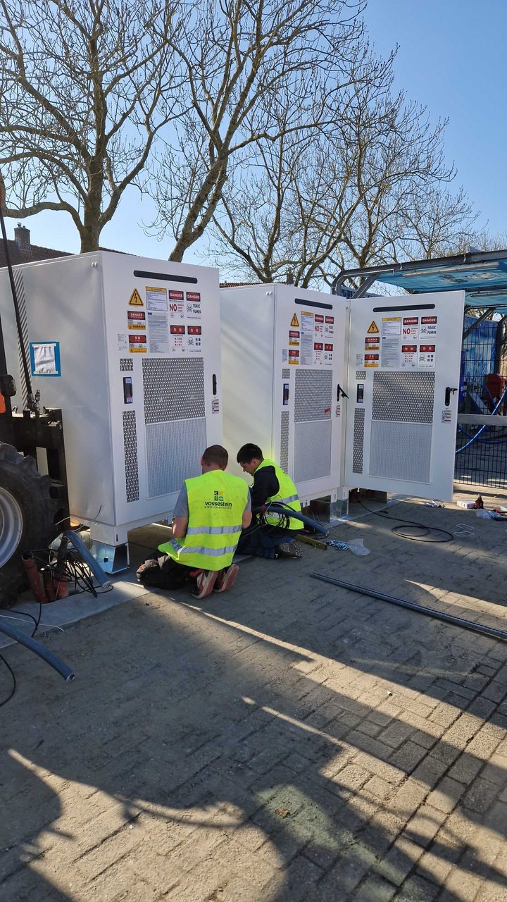 Engineers installing outdoor battery storage cabinets