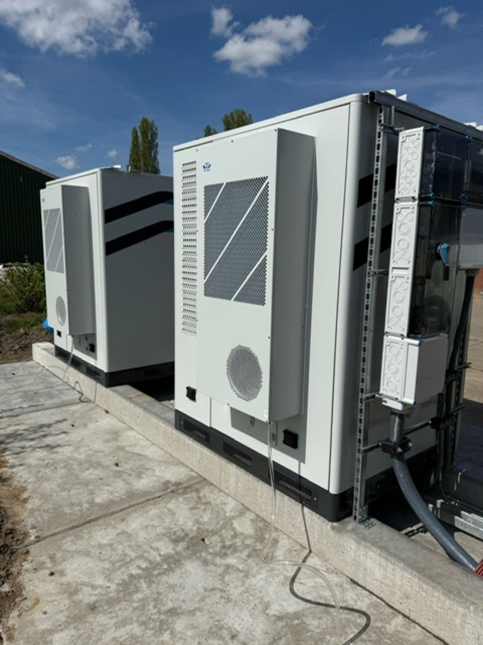 Cooling units on the rear of two outdoor battery storage cabinets