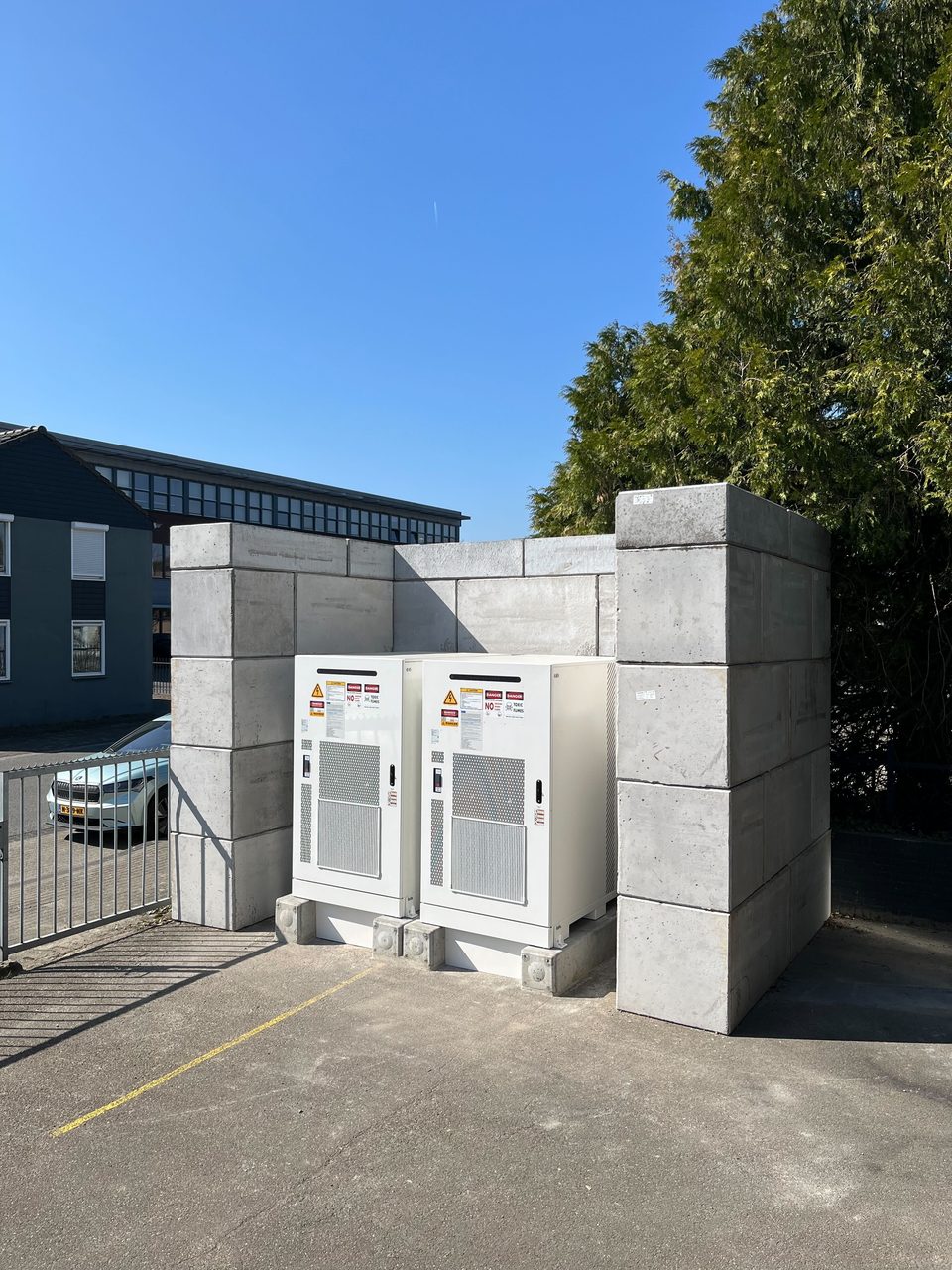 Battery storage cabinets within a protective concrete enclosure