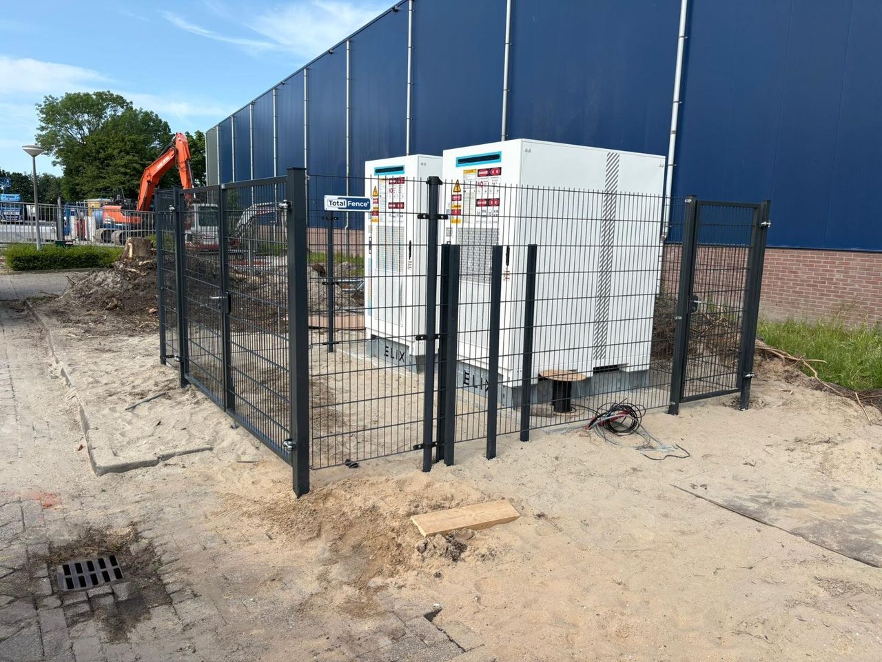 Newly installed battery storage cabinets behind site fencing
