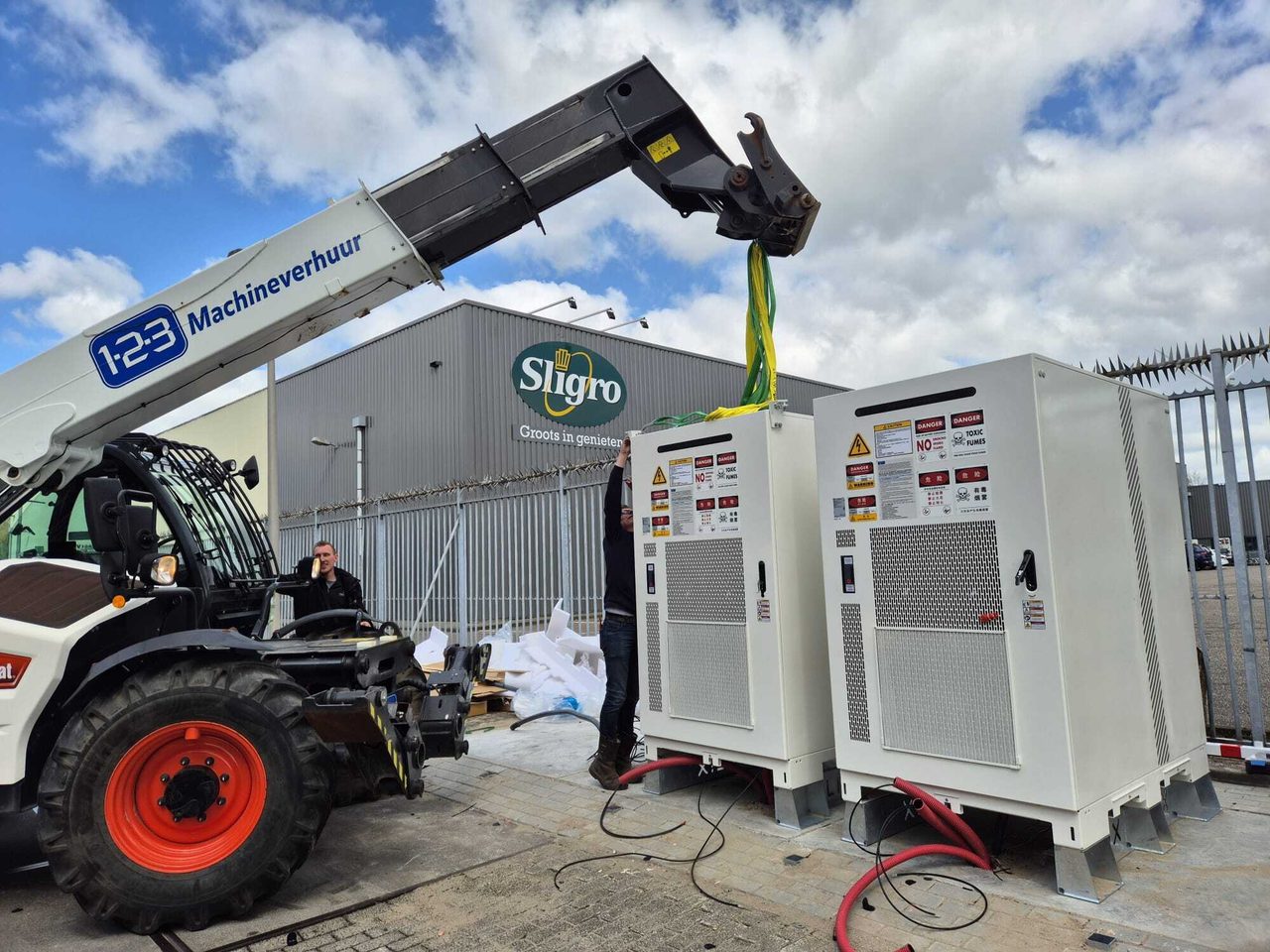 Telehandler placing battery storage cabinets on site